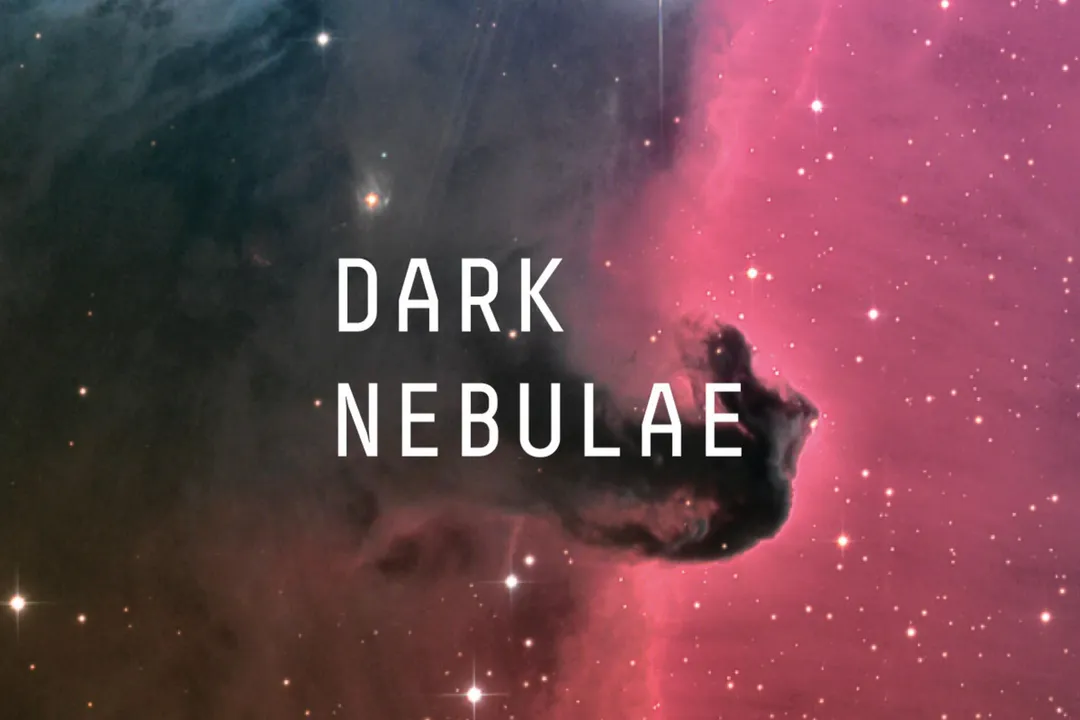 What is the main difference between a dark nebula and an emission nebula?
