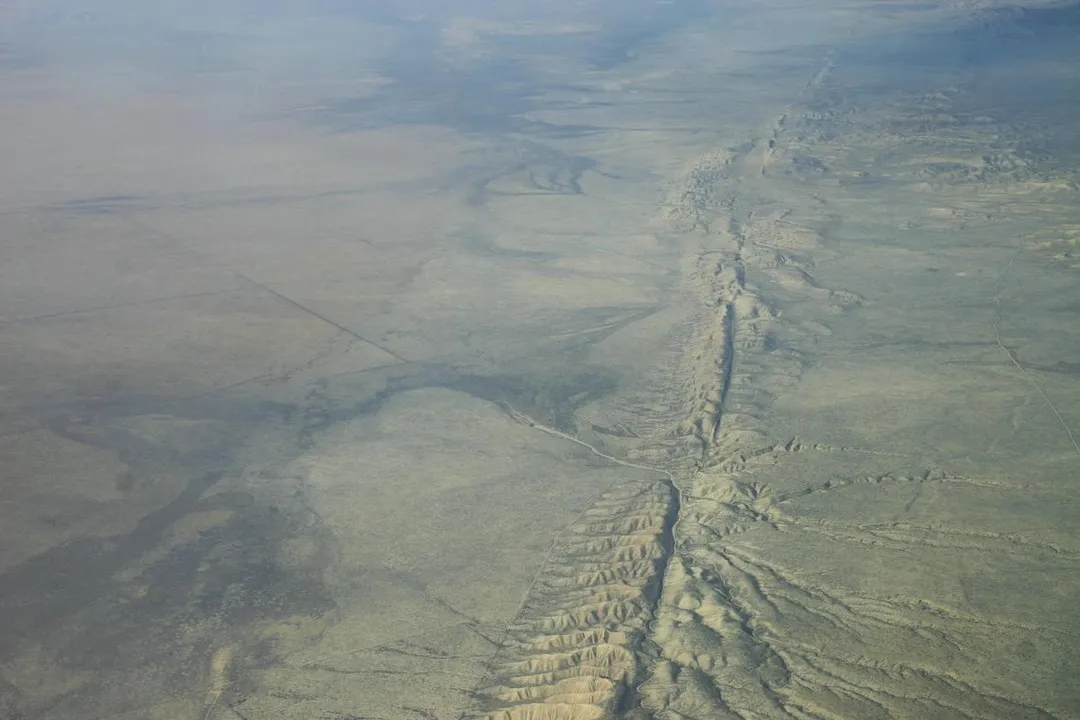What causes earthquakes along fault lines?