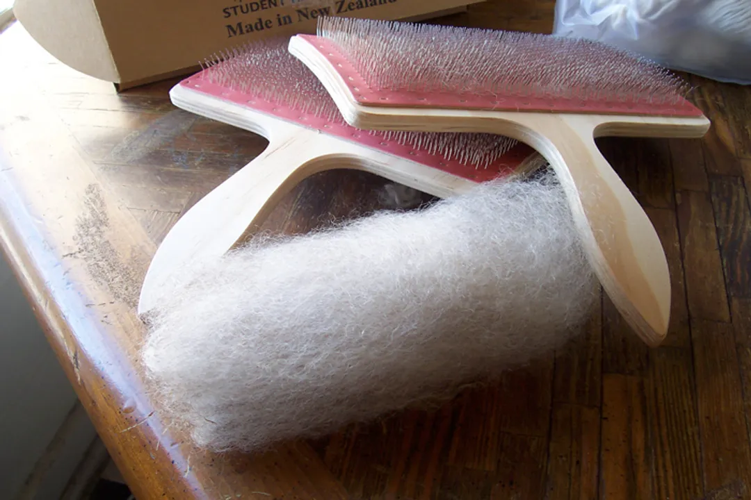 What was used to spin cotton in earlier times?