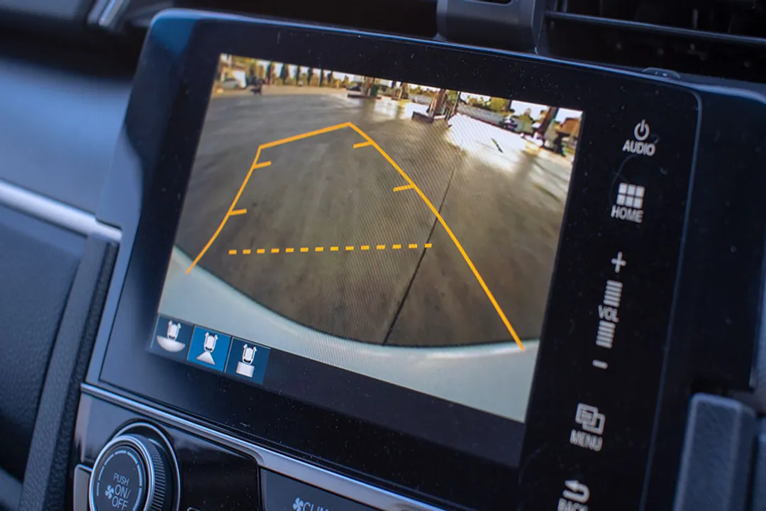 How do ultrasonic parking sensors determine the distance to a solid object?