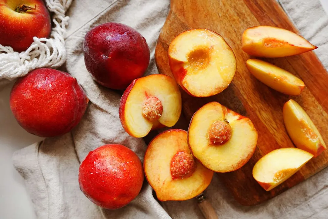 What is the most immediate physical difference between a nectarine and a peach?